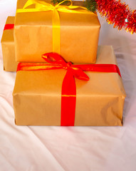Boxes with gifts on a light, blue background and under the Christmas tree. Gift in the hand. Christmas presents, Nicholas Day, Valentine's Day. Bright boxes with bright ribbons Gifts in Macro.