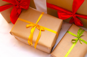 Boxes with gifts on a light, blue background and under the Christmas tree. Gift in the hand. Christmas presents, Nicholas Day, Valentine's Day. Bright boxes with bright ribbons Gifts in Macro.