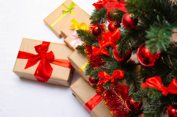 Boxes with gifts on a light, blue background and under the Christmas tree. Gift in the hand. Christmas presents, Nicholas Day, Valentine's Day. Bright boxes with bright ribbons Gifts in Macro.