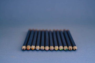 a bunch of pencils on a blue background with colored rods.