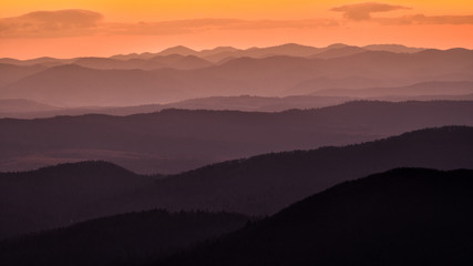 Splendid mountain sunrise. Mountains silhouettes on a beauty background. Bieszczady Mountains Poland.