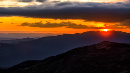 Splendid mountain sunrise. Mountains silhouettes on a beauty background. Bieszczady Mountains Poland.