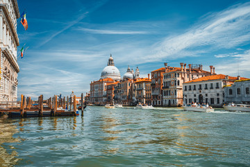 Pleasure tourist boats on Grand Canal and Basilica Santa Maria della Salute, Venice, Italy