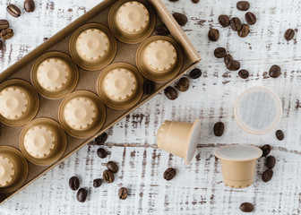 Coffee capsules made from wood. Wooden espresso coffee Capsules, Background from WOODEN Espresso coffee Capsules and coffee beans.  Zero Waste and no plastic concept