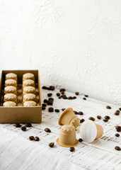 Coffee capsules made from wood. Wooden espresso coffee Capsules, Background from WOODEN Espresso coffee Capsules and coffee beans.  Zero Waste and no plastic concept