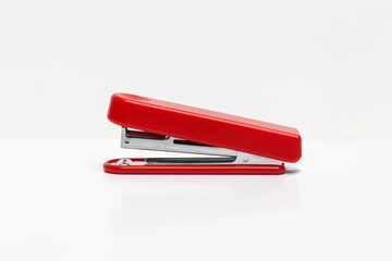 Red stapler isolated on a white background