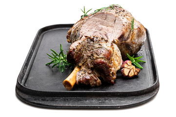 Whole roast lamb leg on grill tray isolated on white