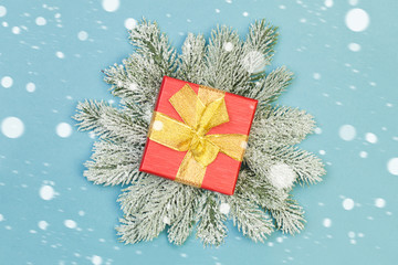 Christmas gift on blue background. Xmas holidays concept with snow