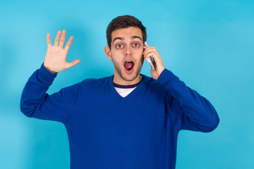 Fototapeta premium casual young hipster man with mobile phone isolated on color background