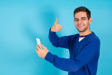 casual young hipster man with mobile phone isolated on color background