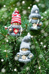 Christmas toys on green fir tree branch, outdoors, close up selective focus
