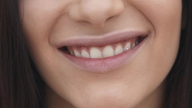 Close-up portrait of female healthy smile at camera