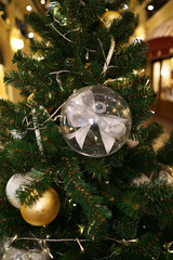 Christmas decorations on the Christmas tree. Transparent balls with a bow inside.