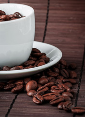 Coffee cup and a scattering of coffee beans