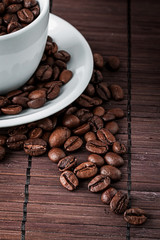 Coffee cup and a scattering of coffee beans