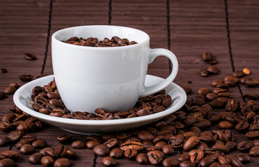 Coffee cup and a scattering of coffee beans