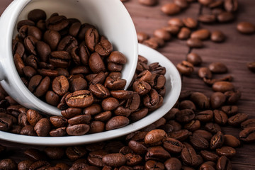 Coffee cup and a scattering of coffee beans