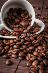Coffee cup and a scattering of coffee beans