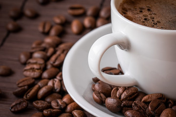 Coffee cup and a scattering of coffee beans