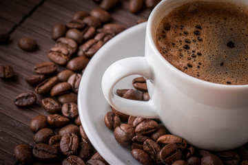 Coffee cup and a scattering of coffee beans