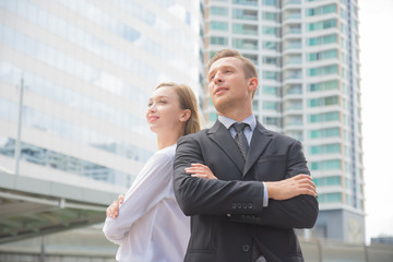 Fototapeta premium businessman and businesswoman are confident in their work to succeed,Office building background,concept success
