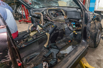 Semi-disassembled car after an accident close-up on the auto Assembly. Concept of car service, auto...