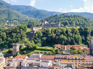 View of the city and the facade of the Collegiata dei Ss. Pietro e Stefano church, with Caltelgrande castle in the background, Bellinzona, Ticino, Switzerland