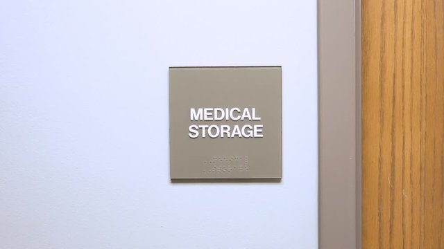 Signs on wall in medical office hospital. slider movement of establishing shot for room inside doctors office.