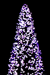 Fototapeta na wymiar Blured Christmas and New Year lights Christmas tree shape.