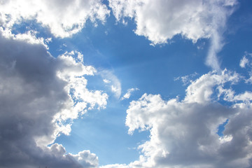 Beautiful blue sky with white clouds of an unusual shape. Clear summer sky with puffy cumulus...