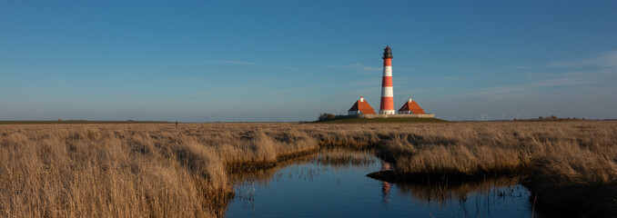 panoramic view to the famous Westerhever lighthouse with salt marshes