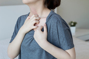 Young woman scratch the itch on her neck, Healthcare concept.