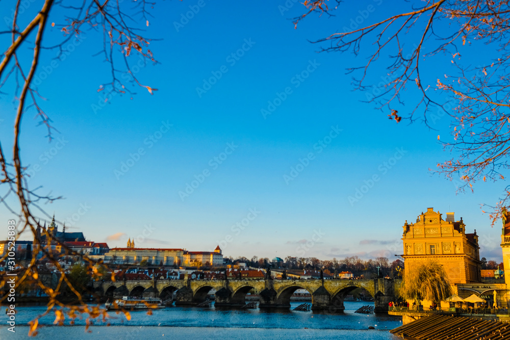 Wall mural landscape with the foreground of the vltava river in prague at sunset