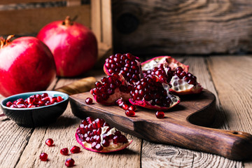 Fresh ripe whole pomegranates,  opened pomegranate  and  seeds