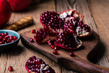 Fresh ripe whole pomegranates,  opened pomegranate  and  seeds