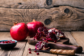 Fresh ripe whole pomegranates,  opened pomegranate  and  seeds