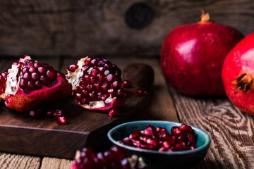 Fresh ripe whole pomegranates,  opened pomegranate  and  seeds