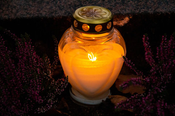Candle burning in front of a grave