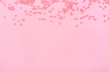 Pink background with tiny hearts. Valentine's day concept. Top view.