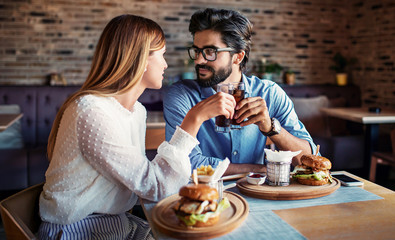 Young couple sitting in a cafe, having breakfast. Love, dating, food, lifestyle concept