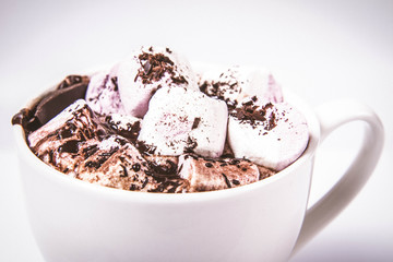 Cup of hot chocolate with marshmallows on a white background