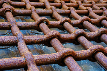 Ancient rusty wrought iron lattice, decorative security element. Old lattice on window of an old...