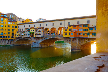 Fototapeta na wymiar Beautiful landscape view of colorful Florence city with famous medieval stone bridge Ponte Vecchio and the Arno River at sunset light. Firenze scenery panorama, Italy Europe. Italian summer vacation.