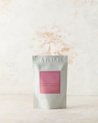 Aluminum bag for tea, coffee, seasonings and other bulk substances with a pink label for signature on a light background.
