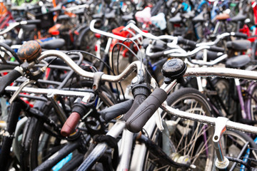 Fototapeta na wymiar Bicycles parked outside Amsterdam Central Station. Close up one old bicycle