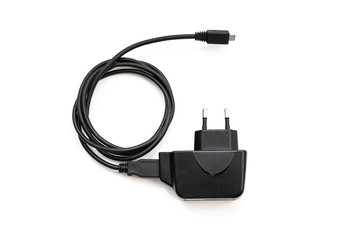 Black power adapter with USB cable for smartphones on a white background.