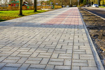 new paved walkway with bicycle lane and with guidelines for visually impaired people