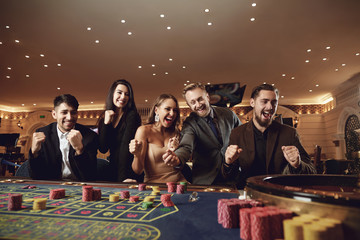 Friends have fun gambling at the weekend in a casino