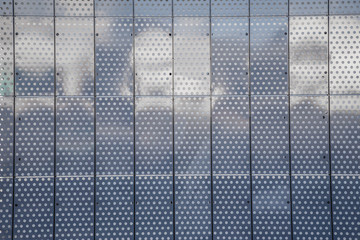 Metal facade tiles background made of perforated steel