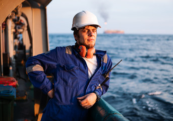 Marine Deck Officer or Chief mate on deck of offshore vessel or ship , wearing PPE personal...